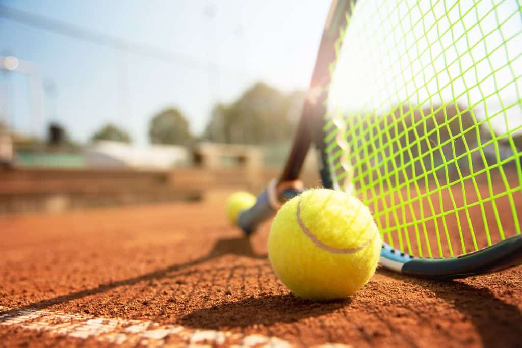 a tennis racket and ball on a Huatulco tennis court