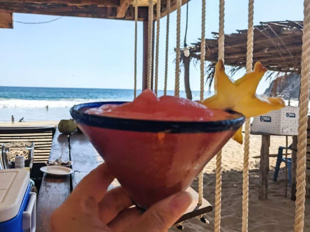 enjoying a strawberry daiquiri at a beach cluck on Playa Zipolite